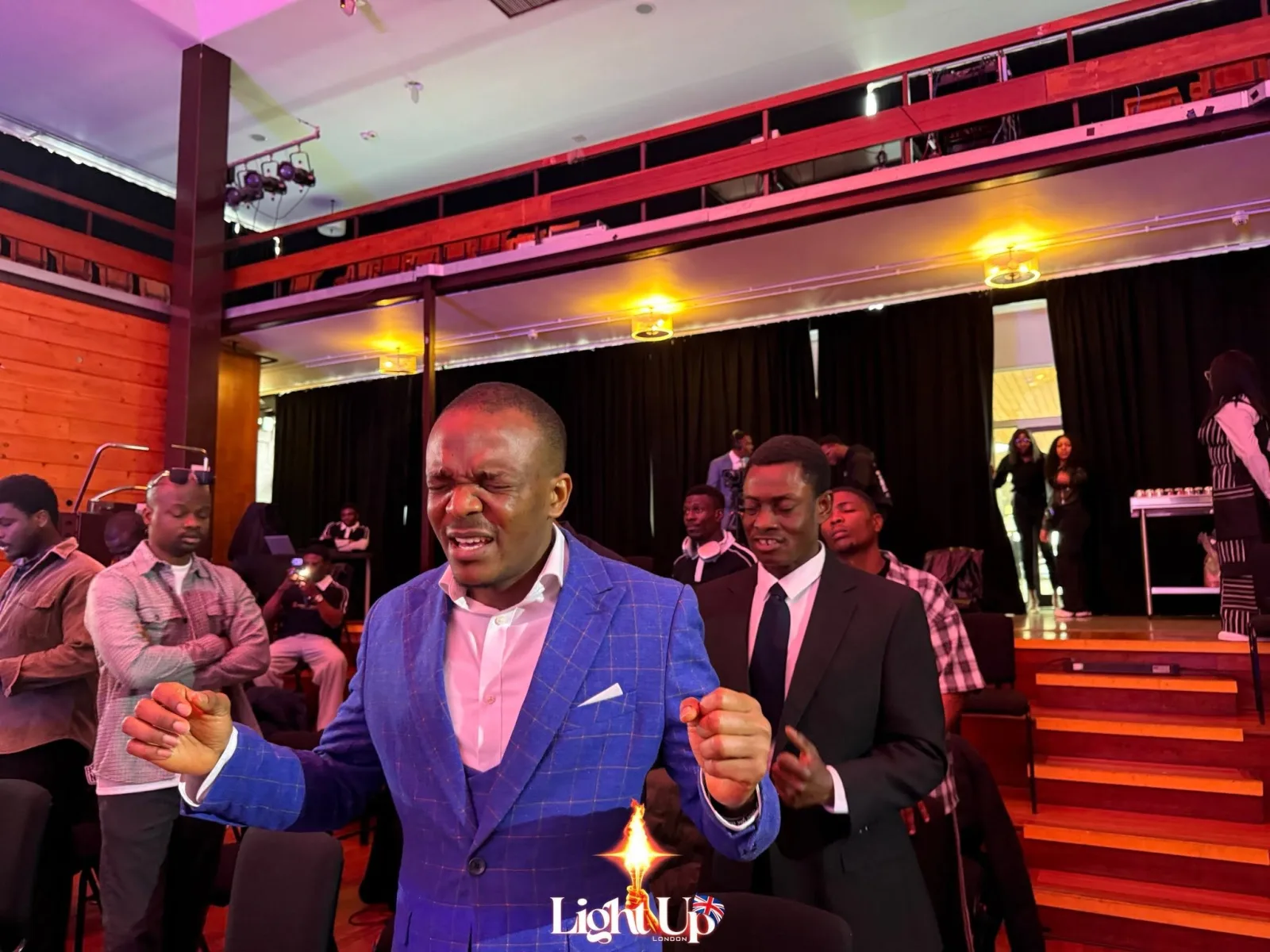 A member of Ambassadors Word United Kingdom praying